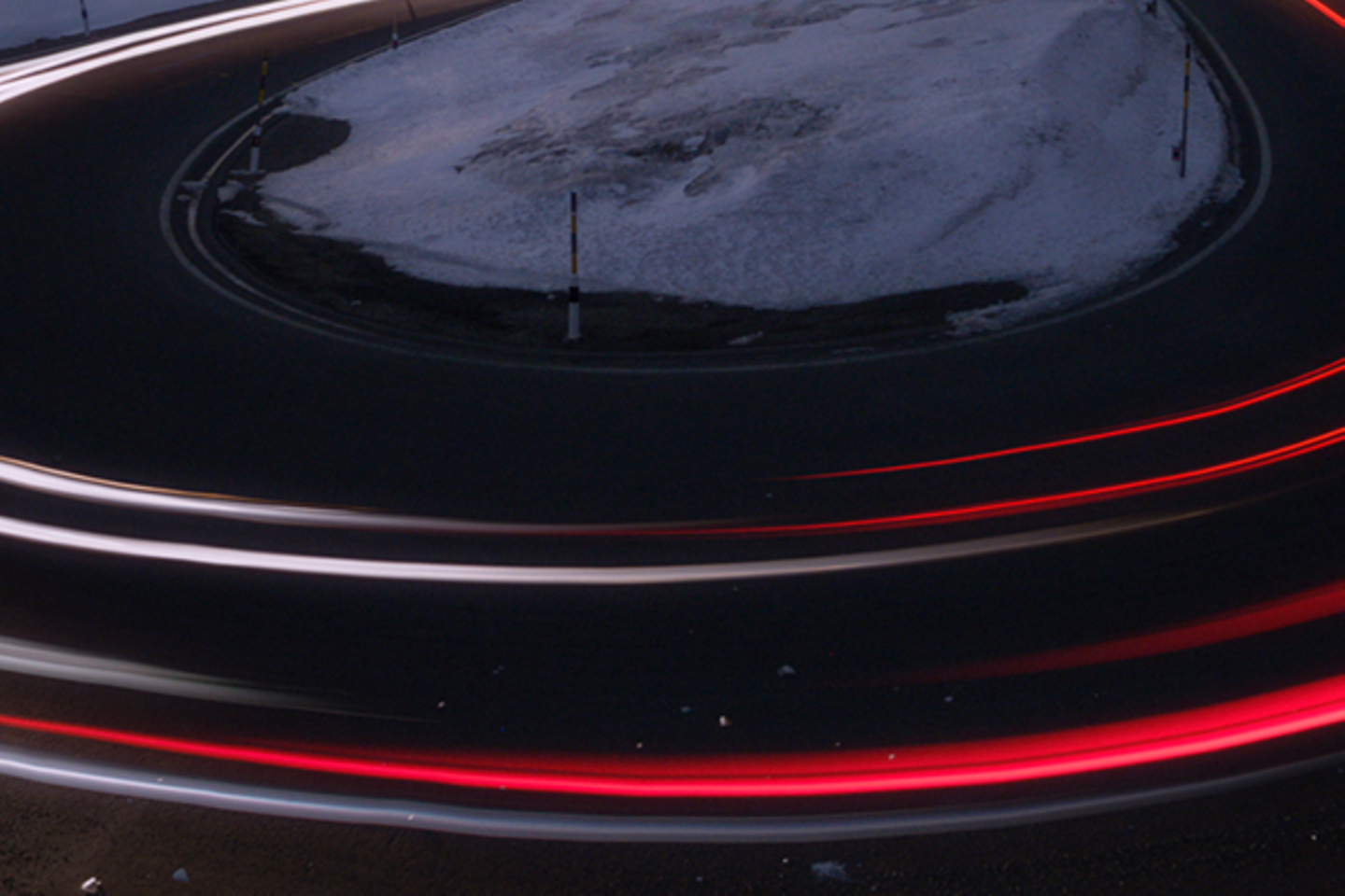 180 degree curve at night and snow with distorted light beams from car taillights