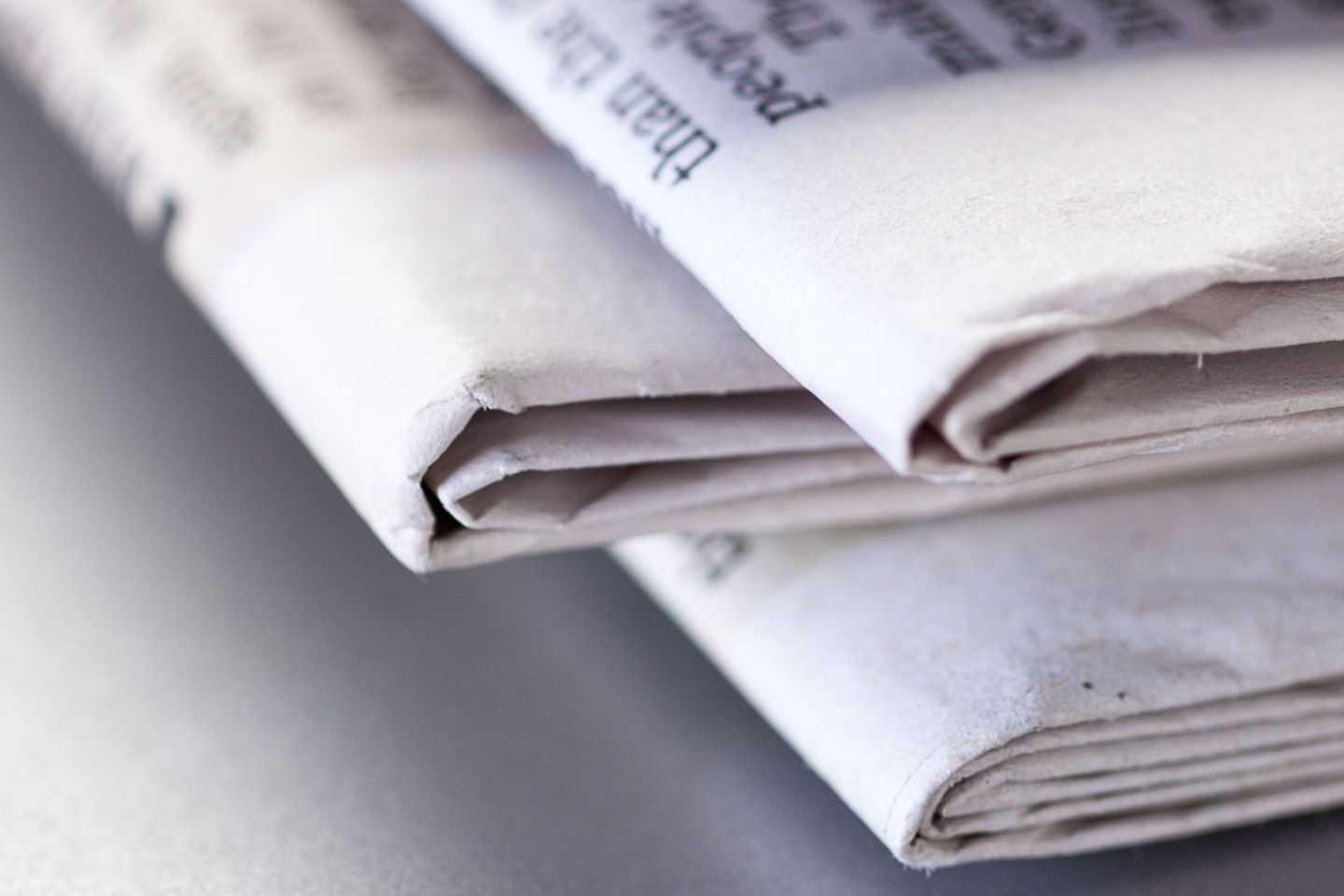 Close-up of the fold of a stack of newspapers