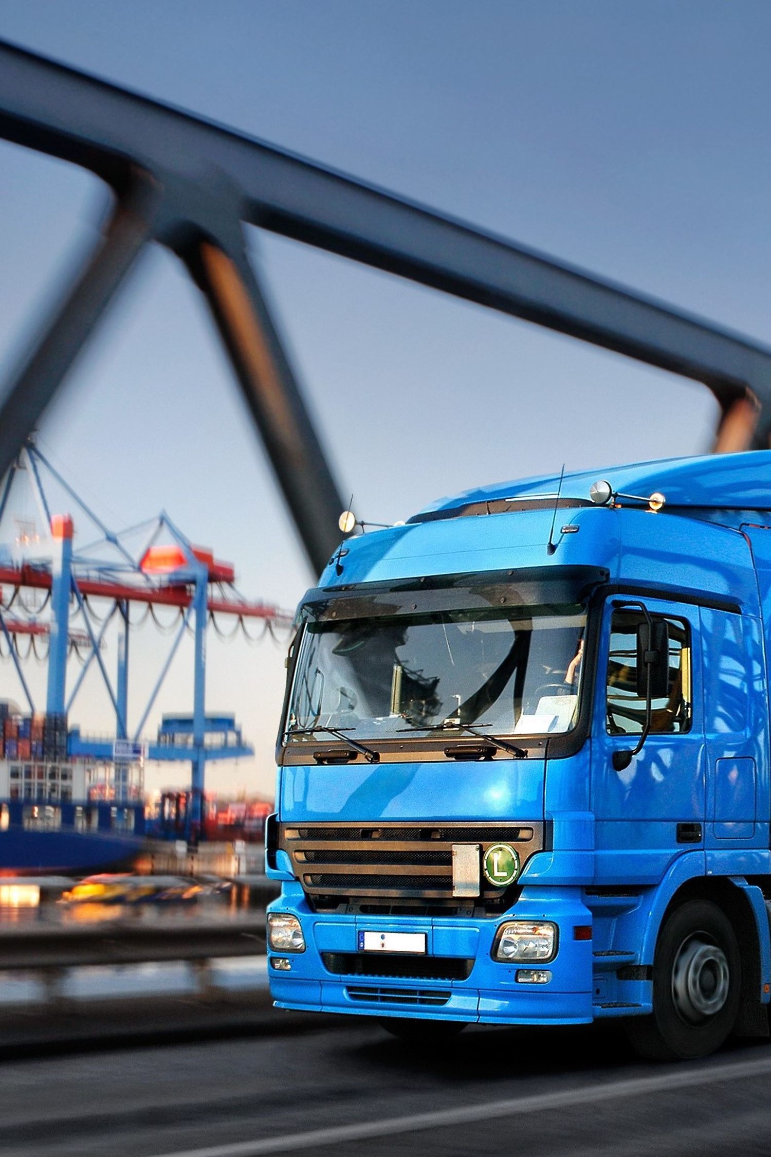 Lorry on a bridge with harbour in the background