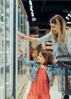 Woman with child shopping in grocery store