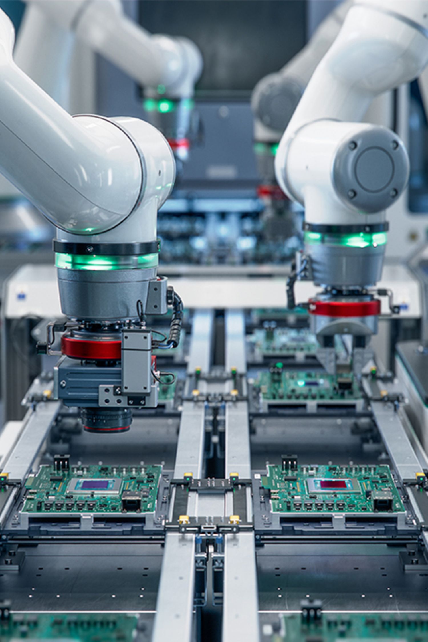 Robotic arms assembling circuits in a modern electronic factory