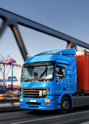 Lorry on a bridge with harbour in the background