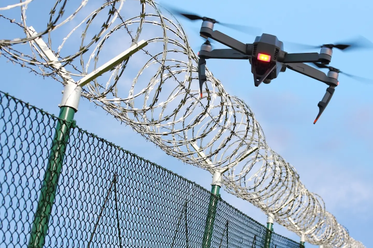 Drone flies over a secured fence