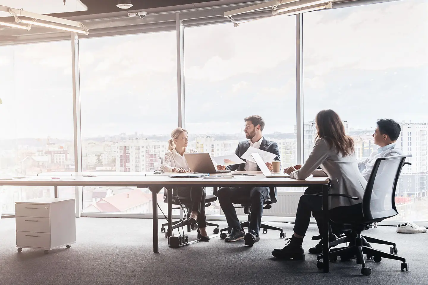 Geschäftsleute arbeiten an einem Projekt in einem modernen Büro mit Panoramablick