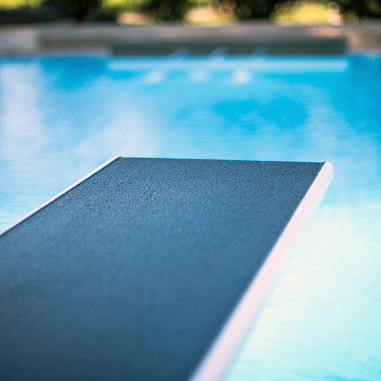 Closeup view of diving board in swimming pool