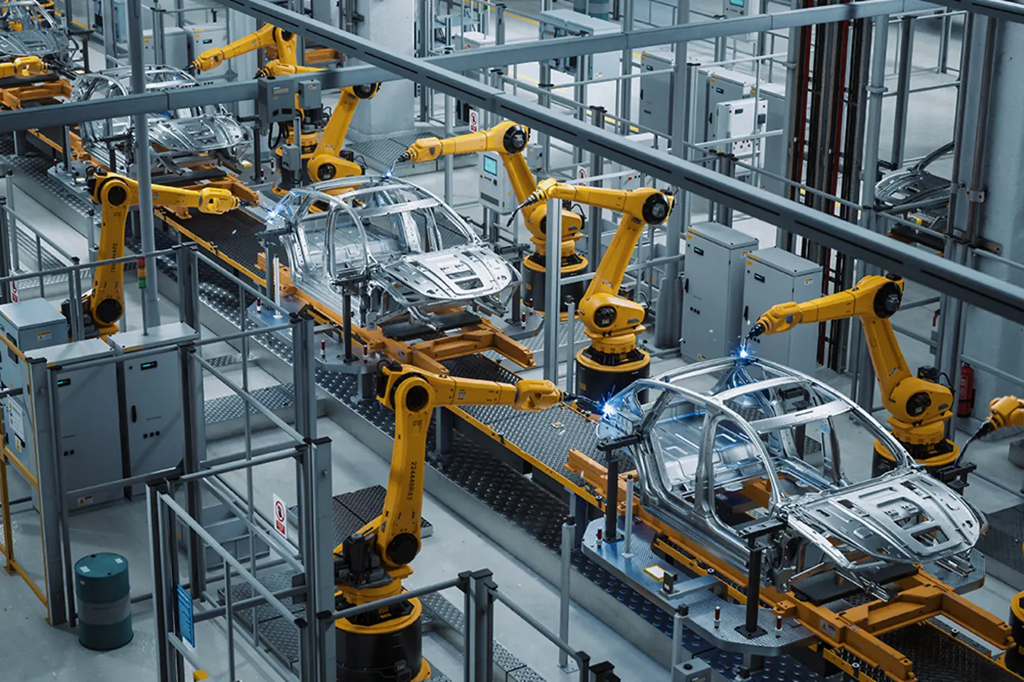 Automated Robot Arm Assembly Line Manufacturing High-Tech Green Energy Electric Vehicles.