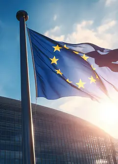 EU-Flagge weht vor einem modernen Gebäude bei Sonnenschein - AI generated/adapted