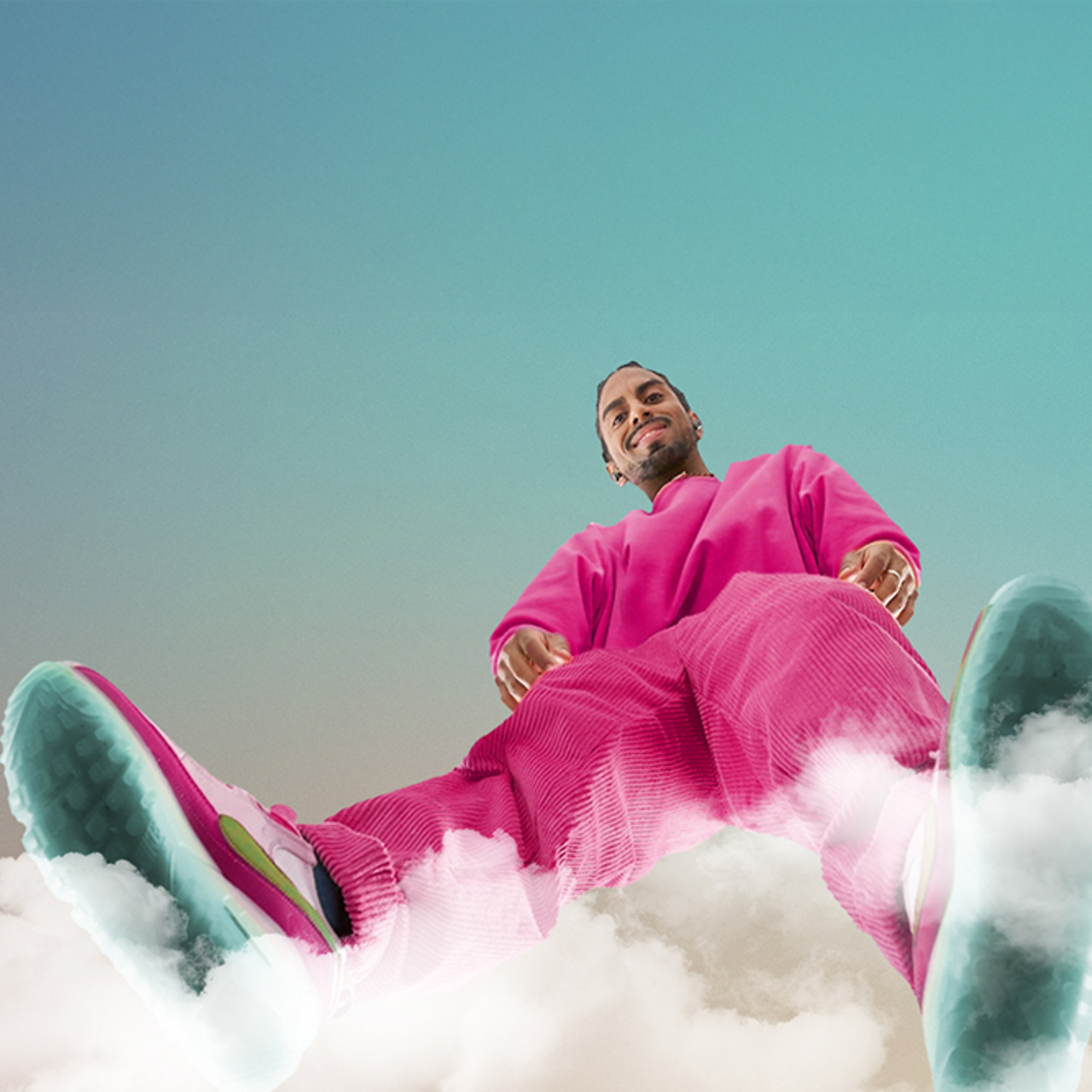 A person in a pink outfit stands on a cloud