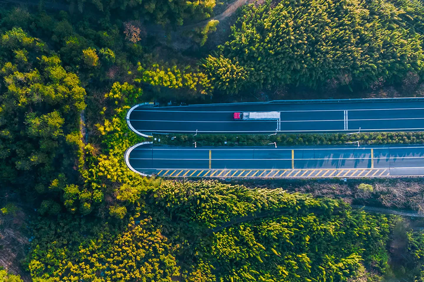 Ansicht aus der Vogelperspektive: Lkw fährt auf Autobahntunnel zu