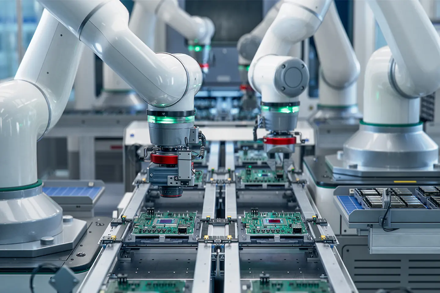 Robotic arms assembling circuits in a modern electronic factory