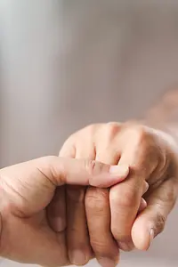 Psychologist provides mental aid to patient holding hand
