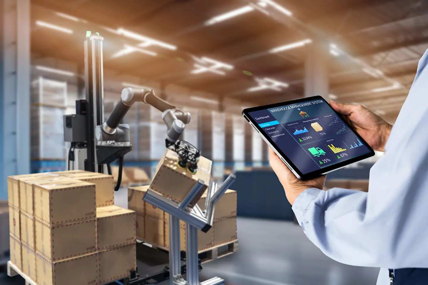Roboterarm wird von Mitarbeiter in Fabrik bedient