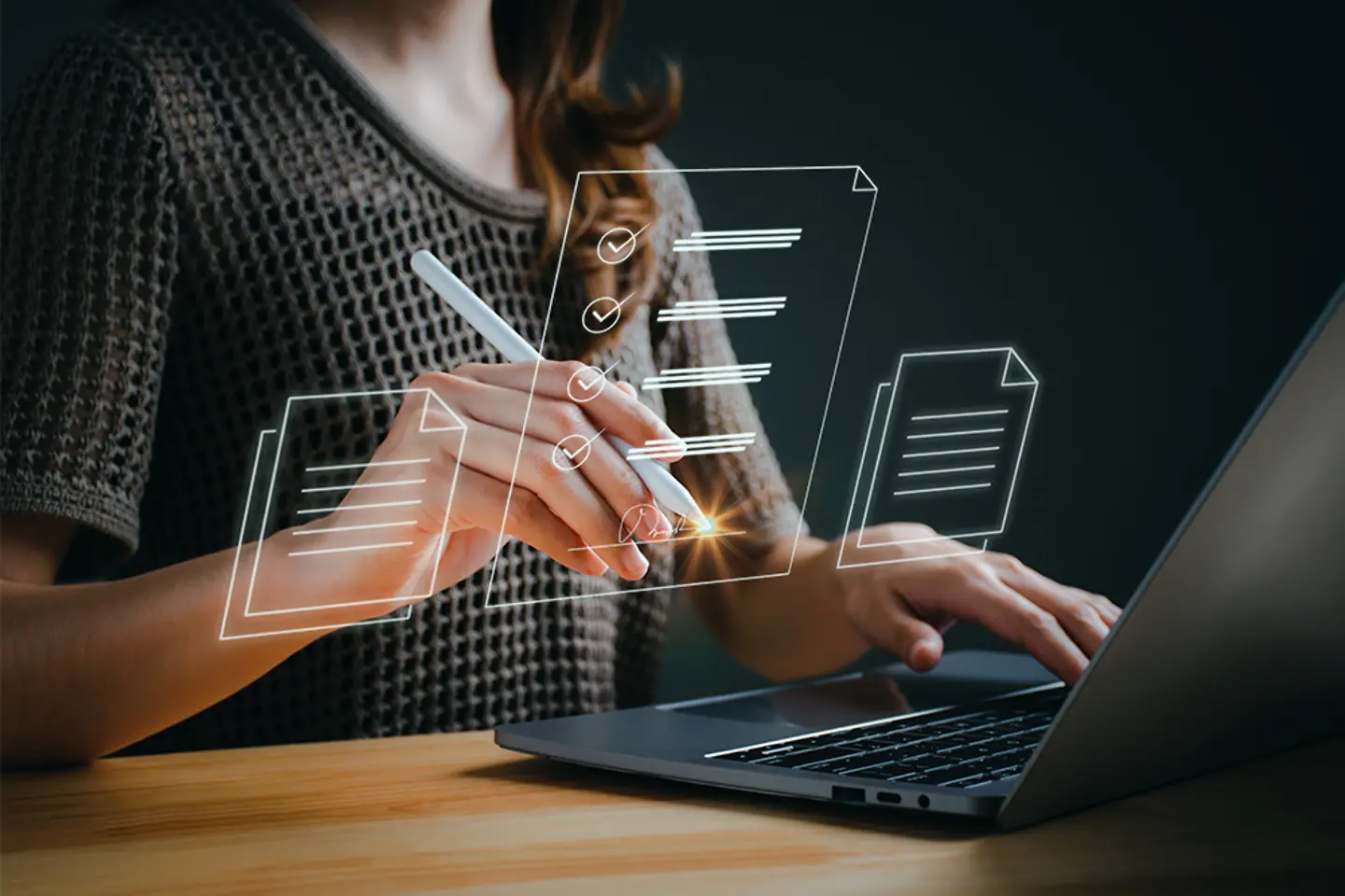 Businesswoman working on laptop with electronics document icons by virtual notebook screen
