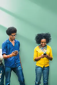 A group of young people with phones, tablets and laptop