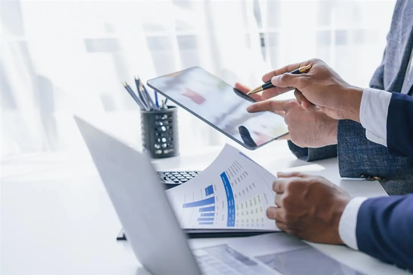 Consultants discussing balance sheets and statistics
