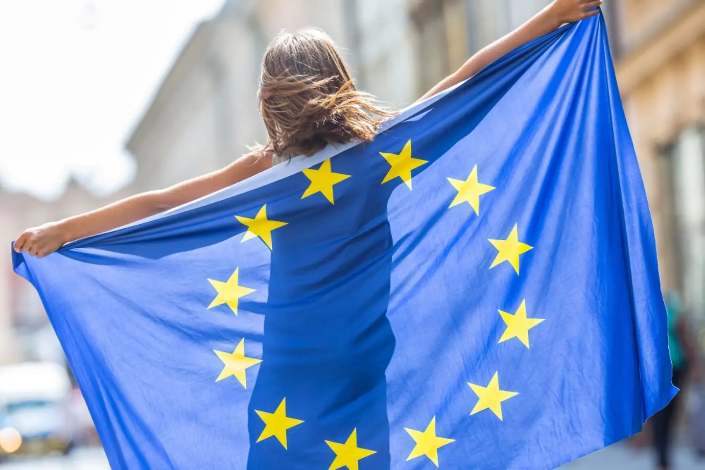 Happy girl waving the European Union flag