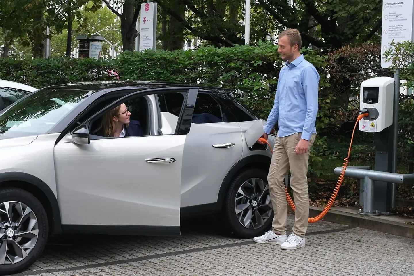 Mann lädt ein Elektroauto an einer Ladestation