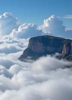 Cliffs of silver rise above a sea of clouds