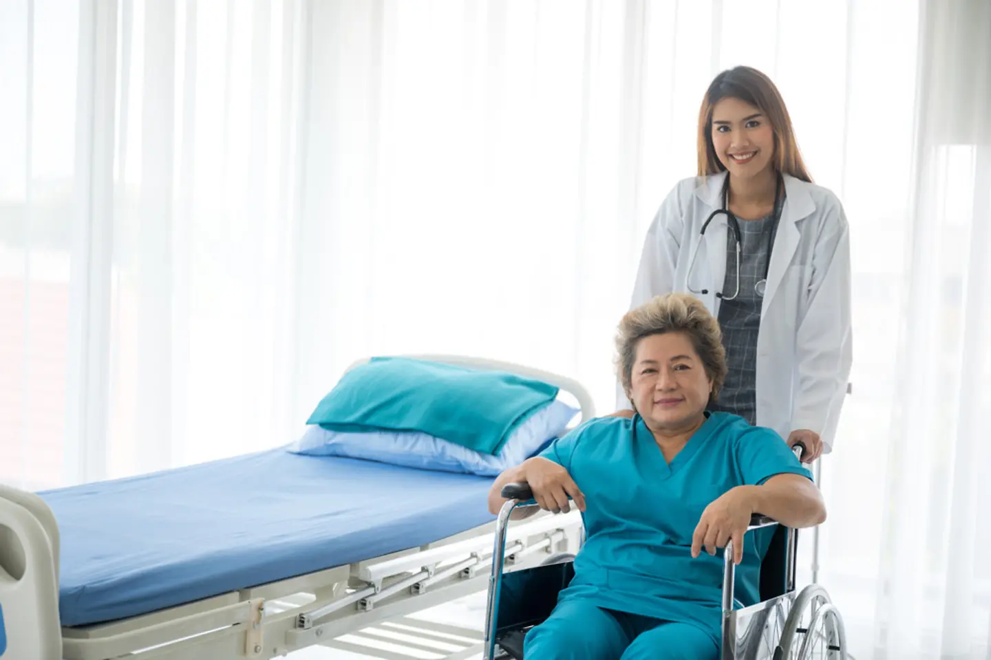 Young, female doctor with a patient in wheelchair