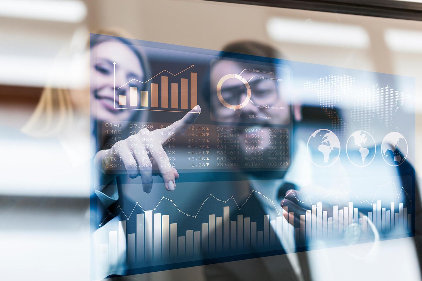 Woman shows man data on a digital bulletin board