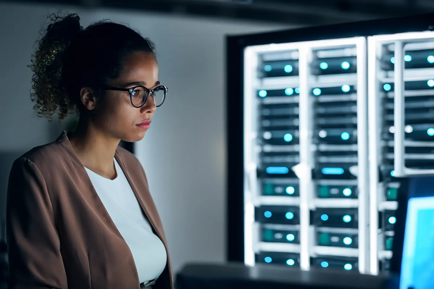 Female engineer working in server room