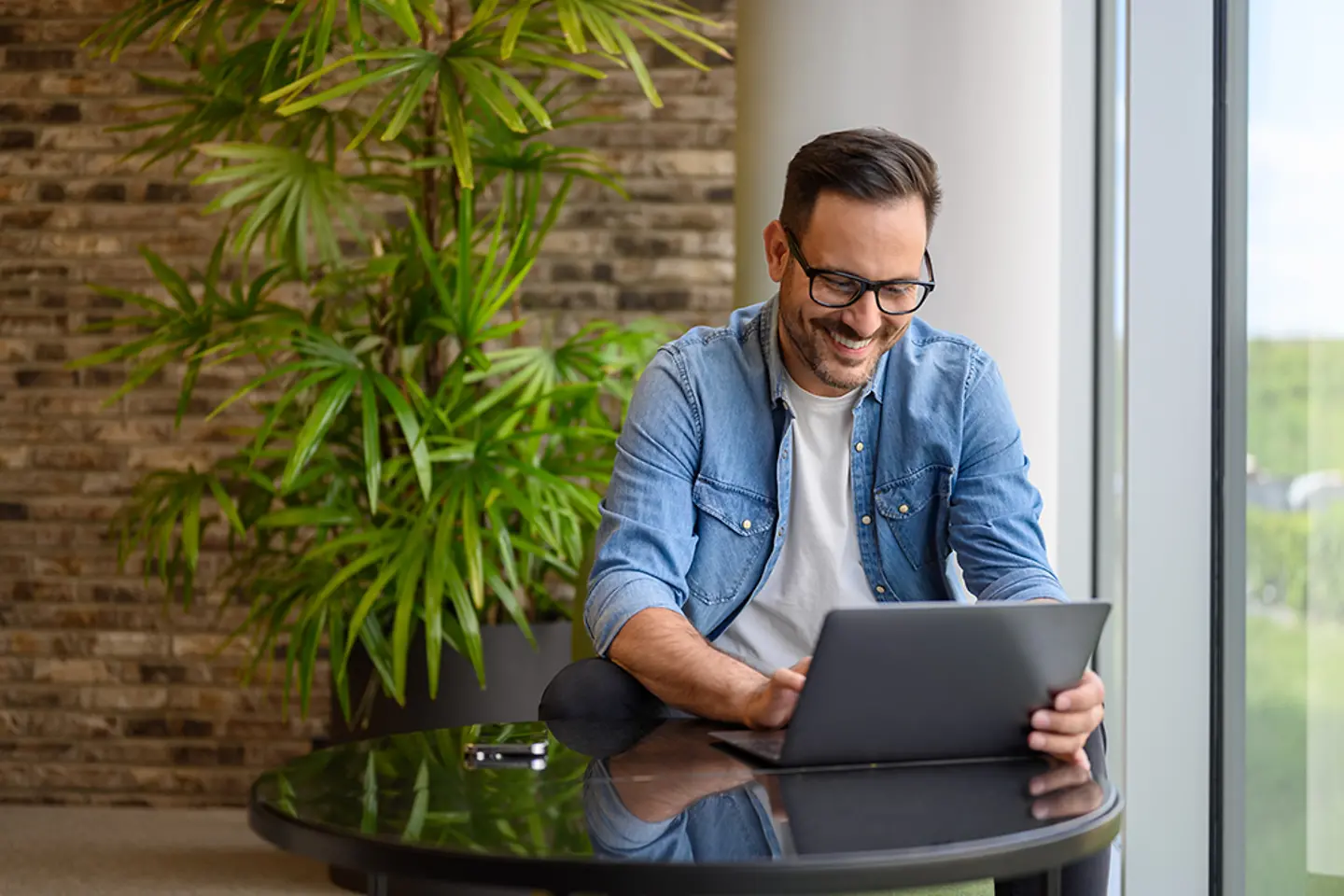 Cloud expert checking data on laptop