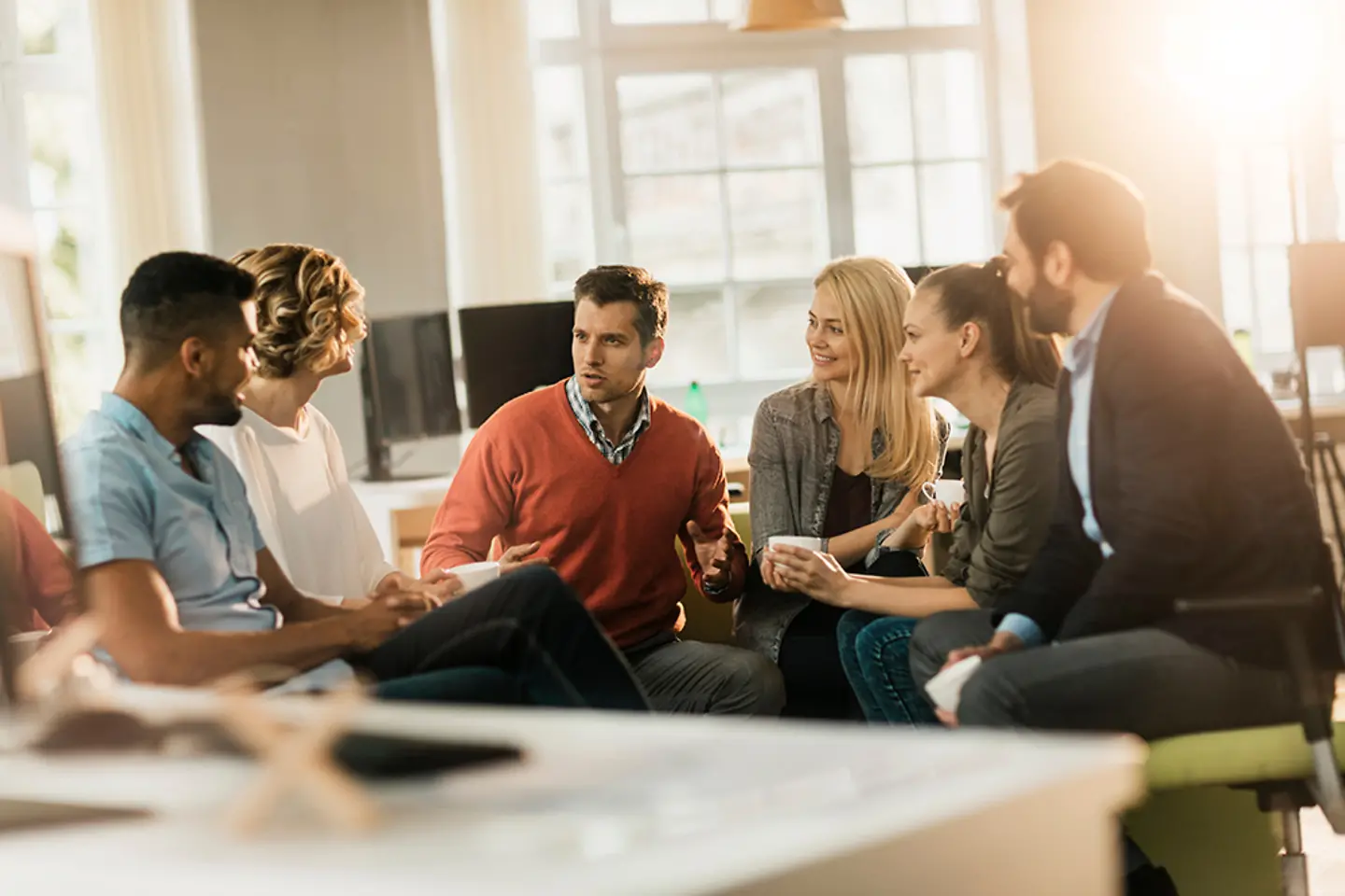 Colleagues discussing tasks in meeting room