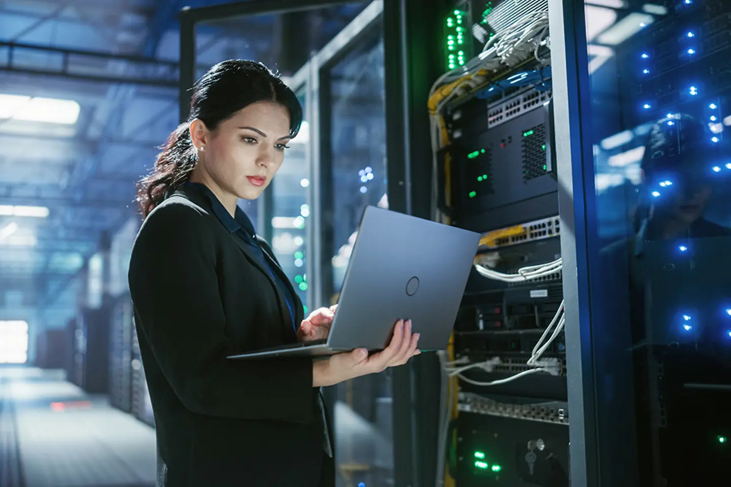 Cyber security expert uses a laptop to check server