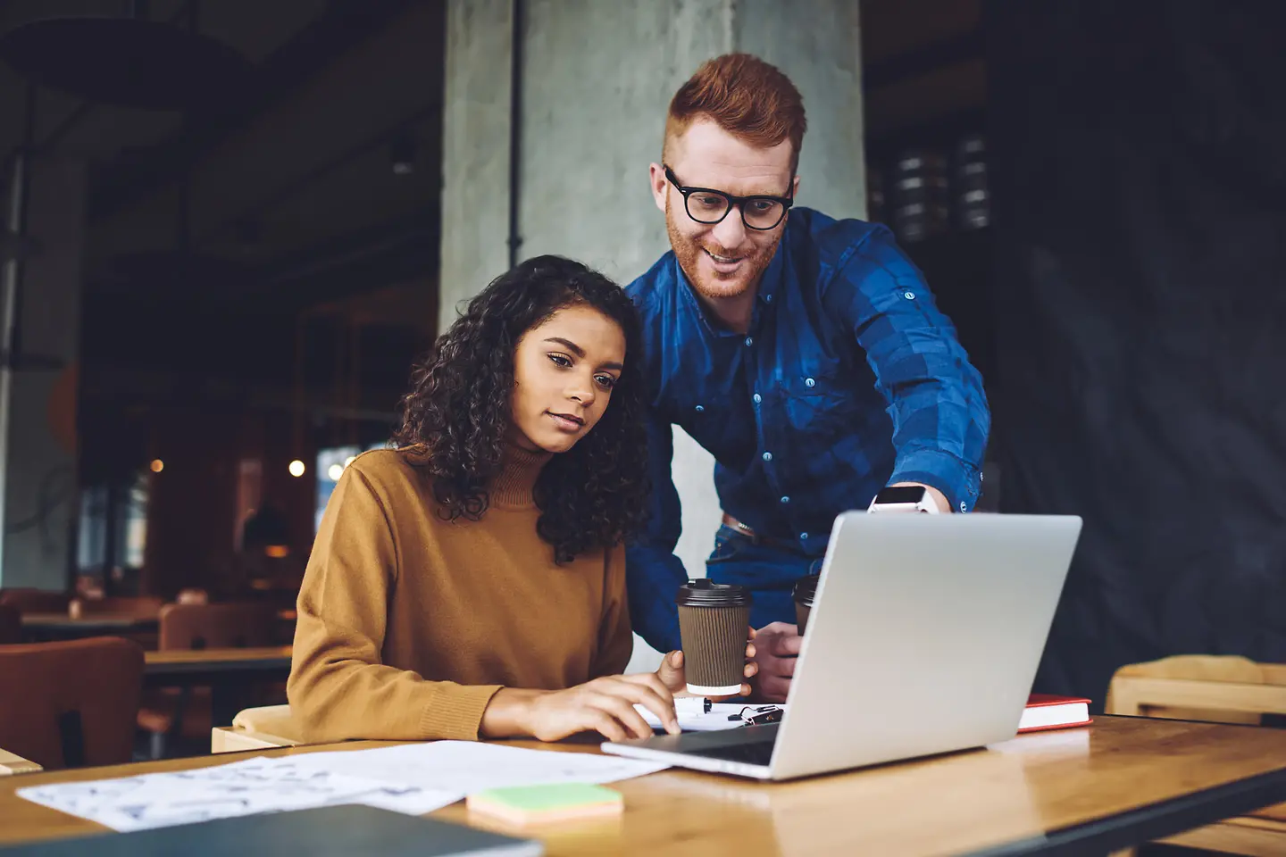 AI-generated image - Two business colleagues in discussion in front of a laptop