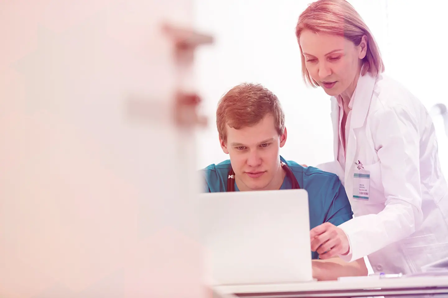 Medical professionals using a laptop to jointly analyze health data