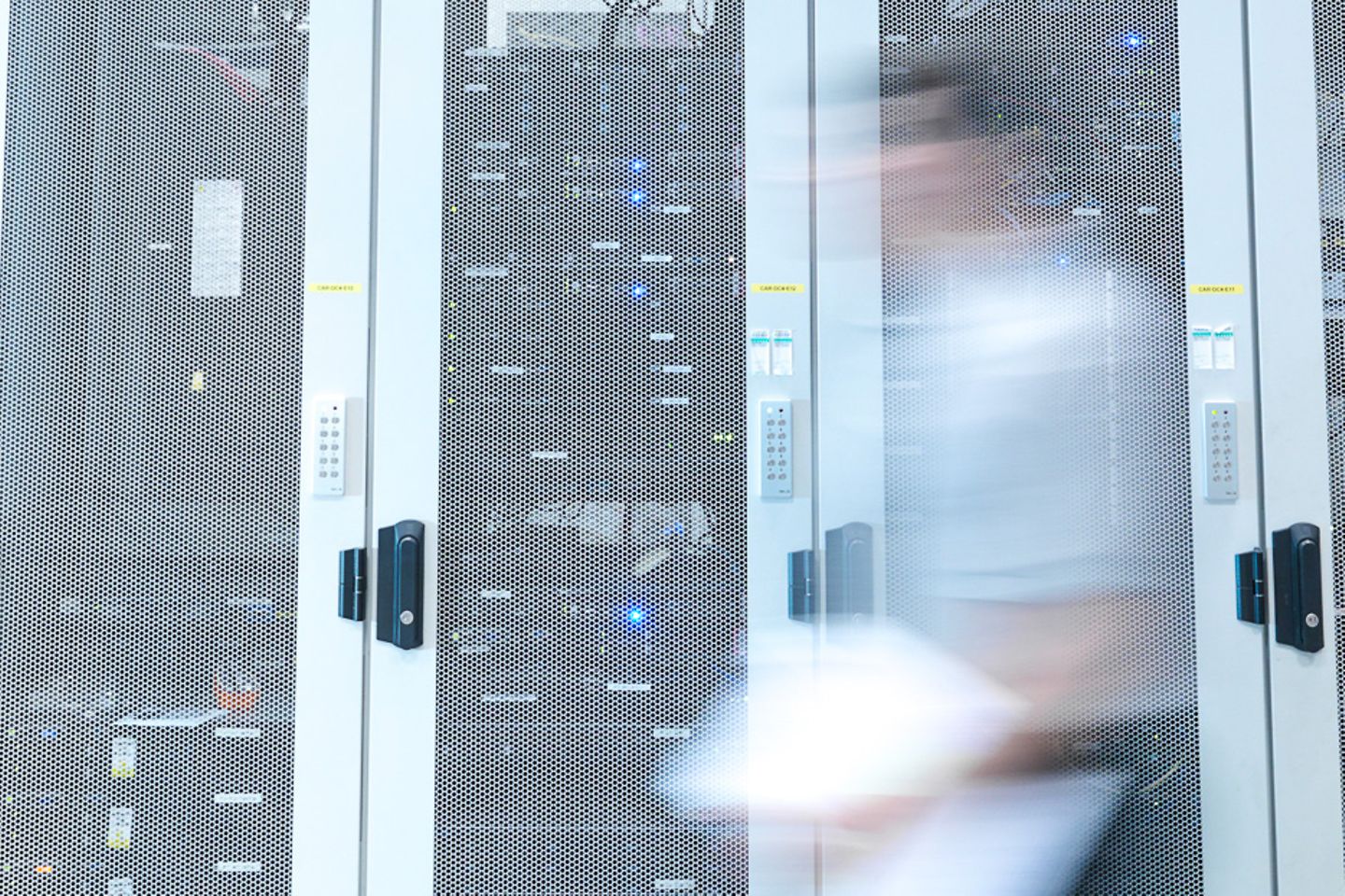 A man walks through a server room