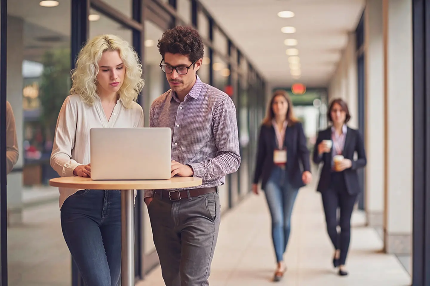 AI-generated image - Colleagues discussing application data in the office hallway