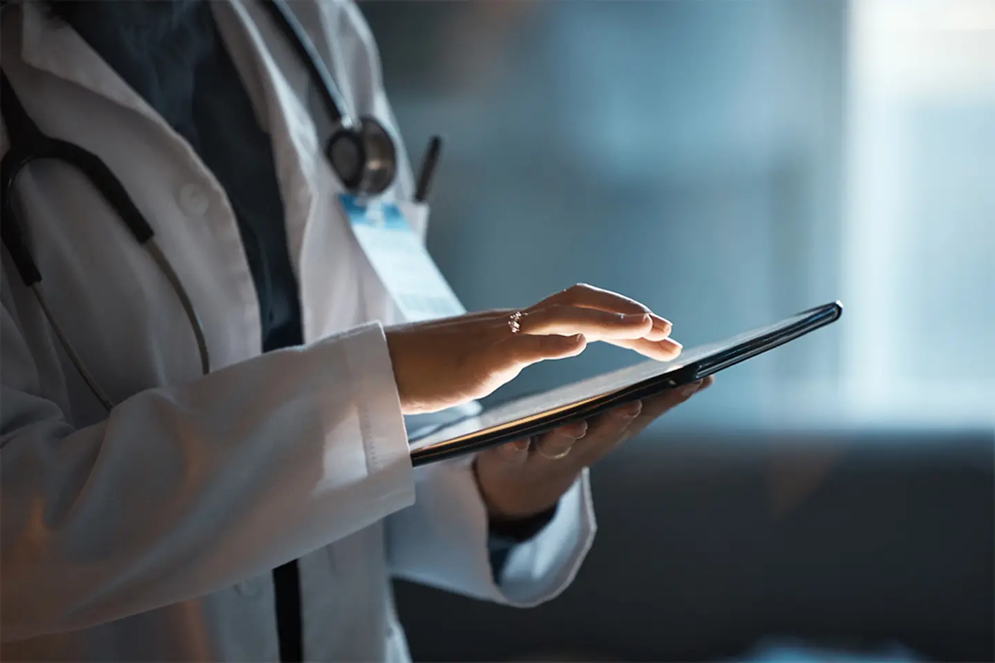 Telehealth, digital tablet and doctor hands for hospital innovation, software management and results update in dark workplace