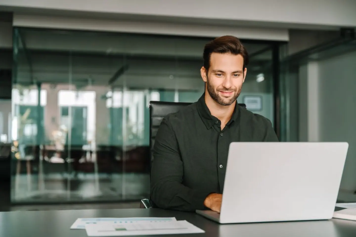 IT specialist reviewing application data on laptop