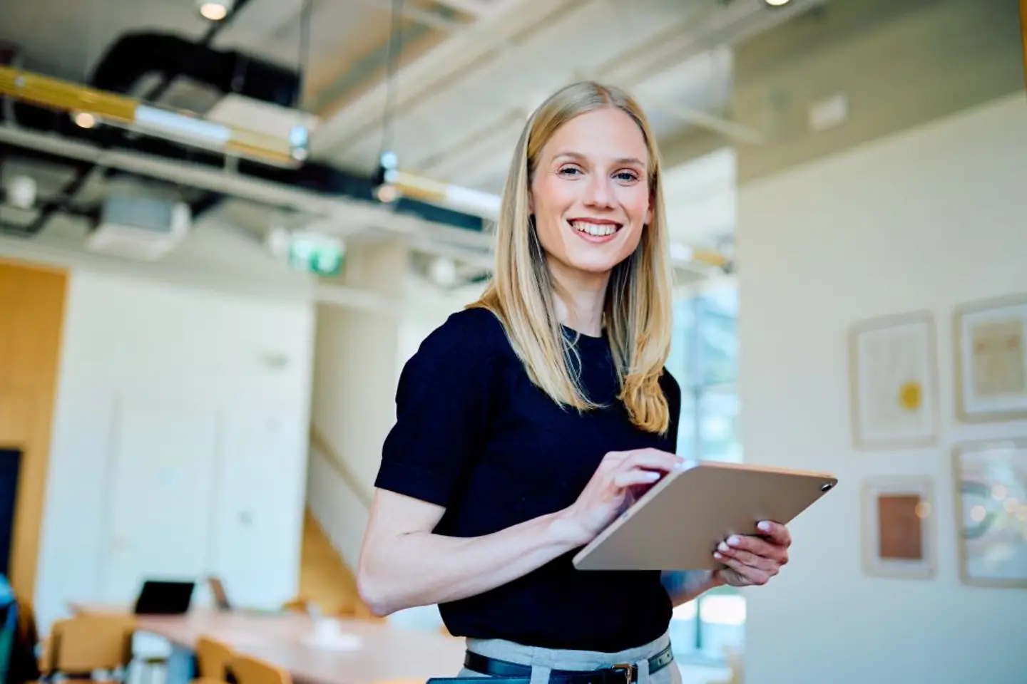 Young business professional checking application data on tablet