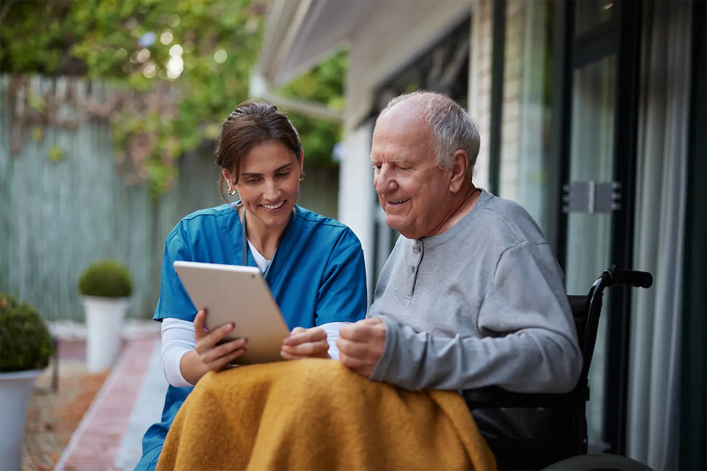 Young nurse showing an older patient his health data