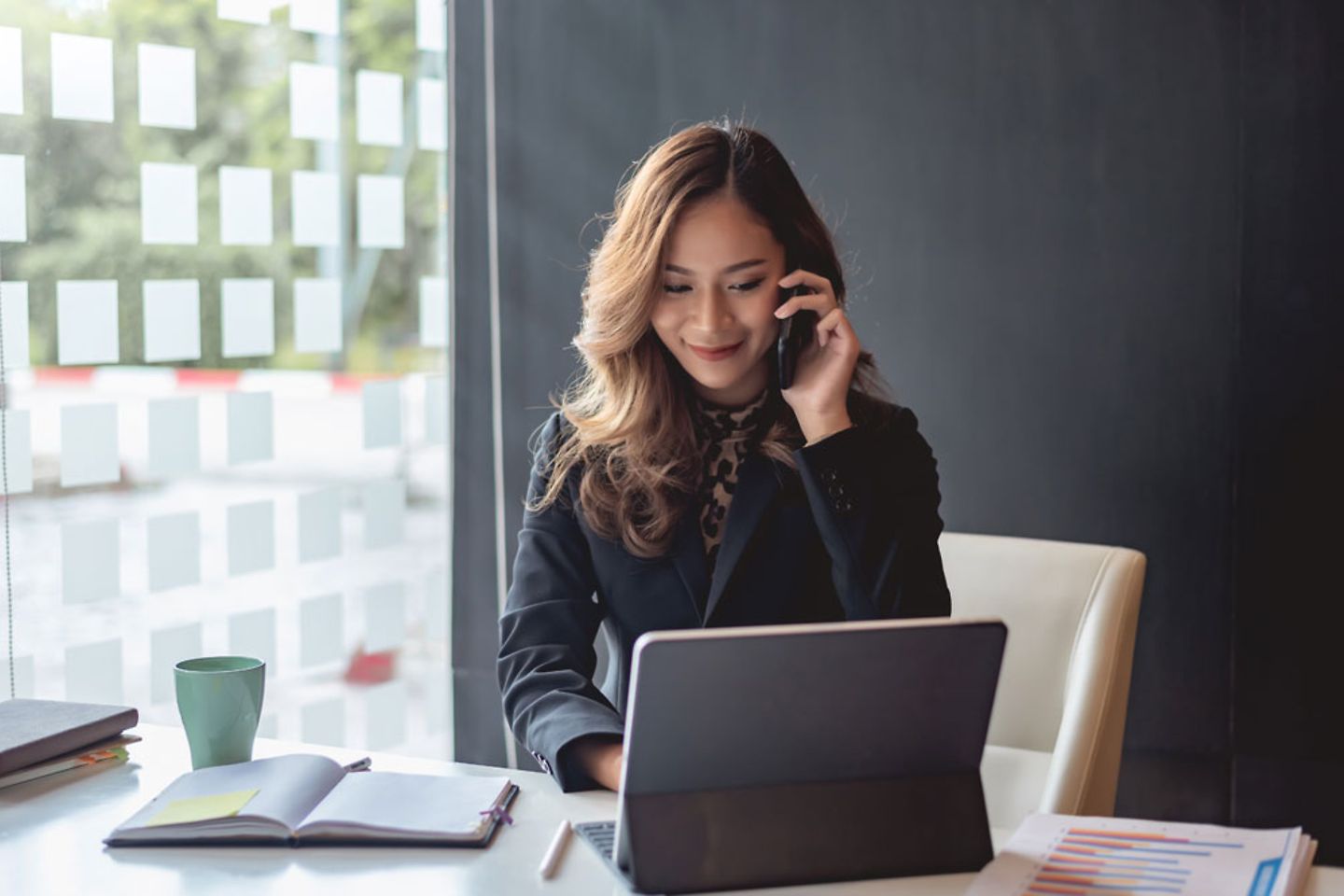 Asian businesswoman talking on the mobile phone in the office.