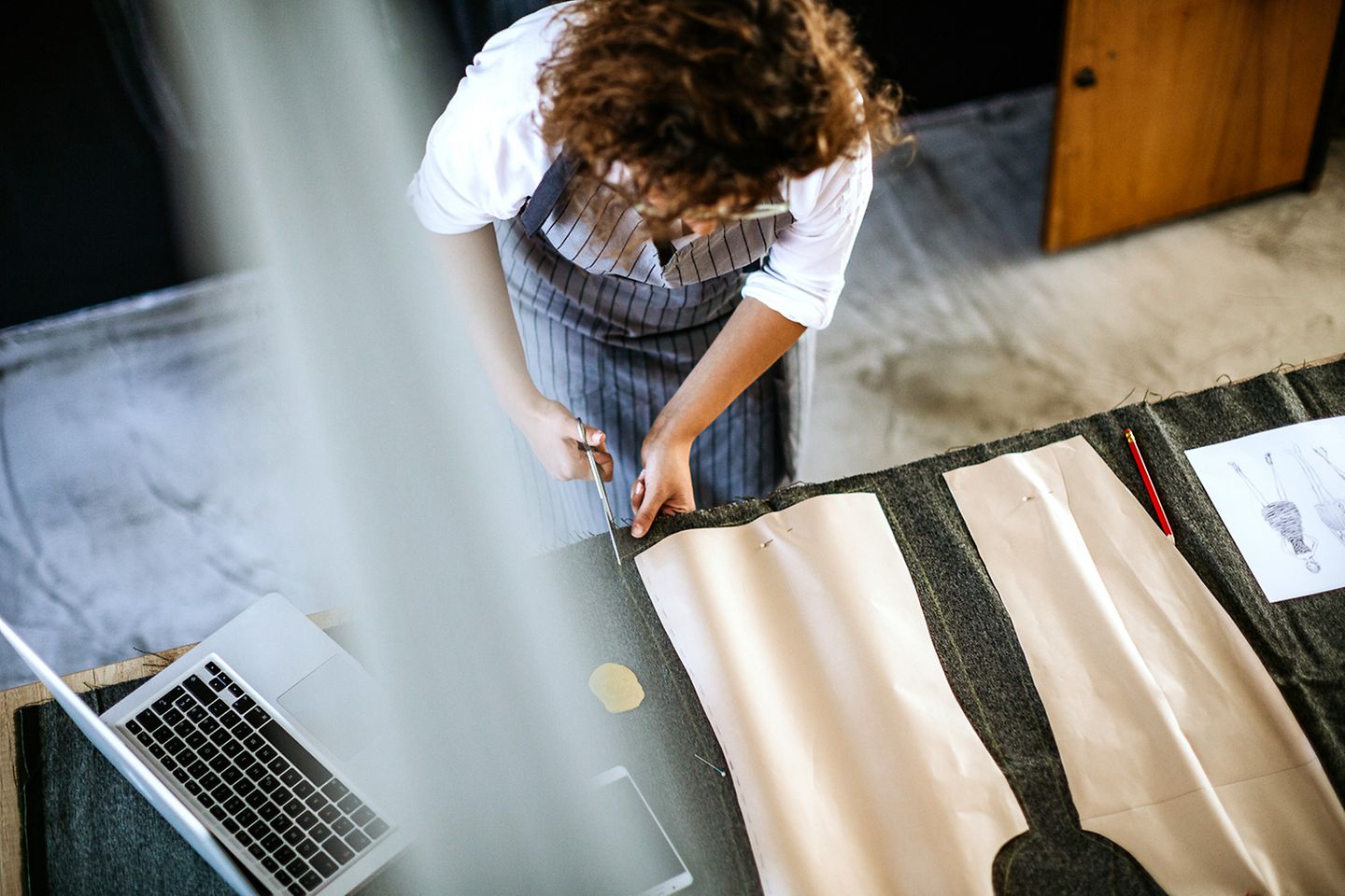 View from above on a table with pieces of fabric that a tailor cuts to size