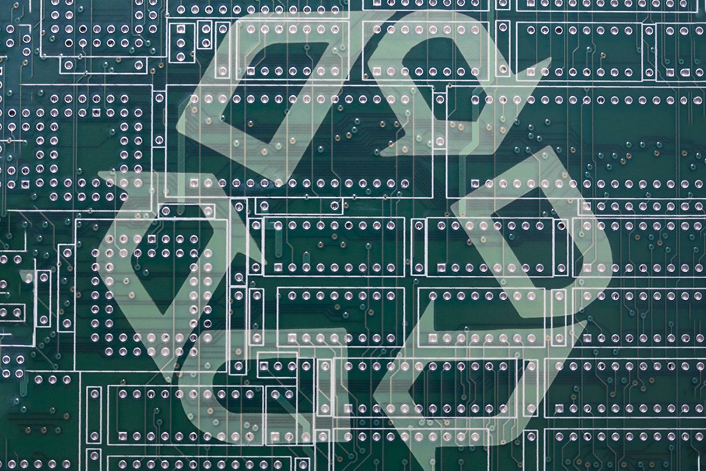 Picture of a computer board with a recycling symbol on top 