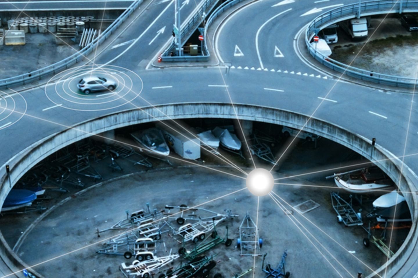 Roundabout from above, in which many cars drive that are connected via digital networks.
