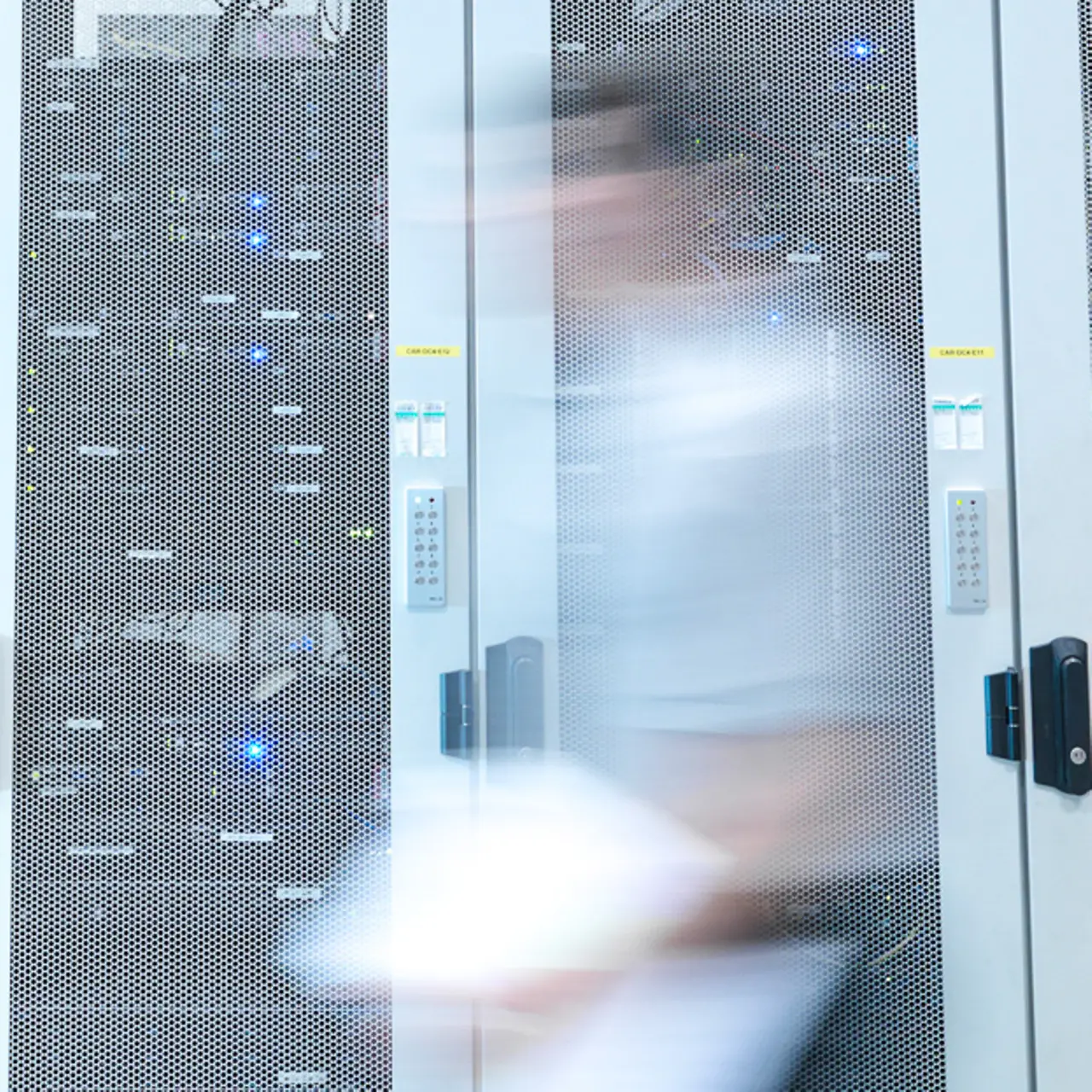 A man walks through a server room