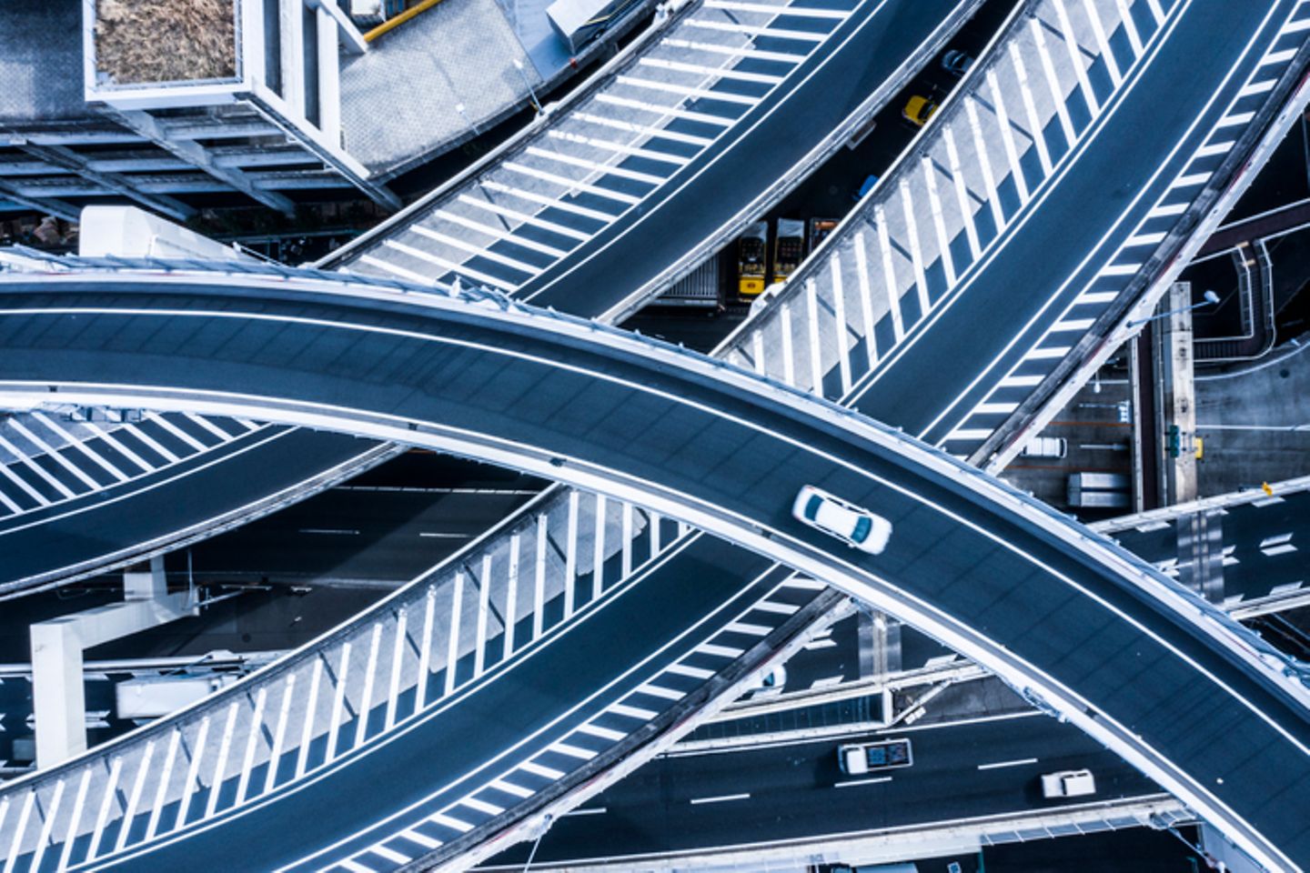 Bird's eye view of various intersecting roads with few cars.