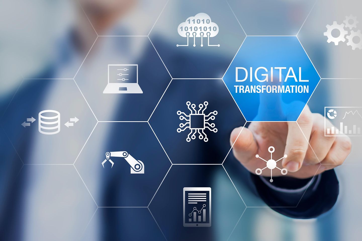 A human finger points to the word "digital transformation" on a digital image.