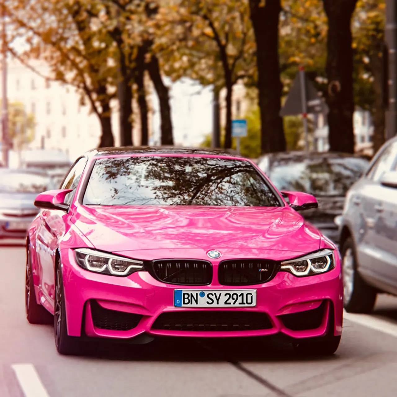 Magenta gefärbtes Auto im Stadtverkehr