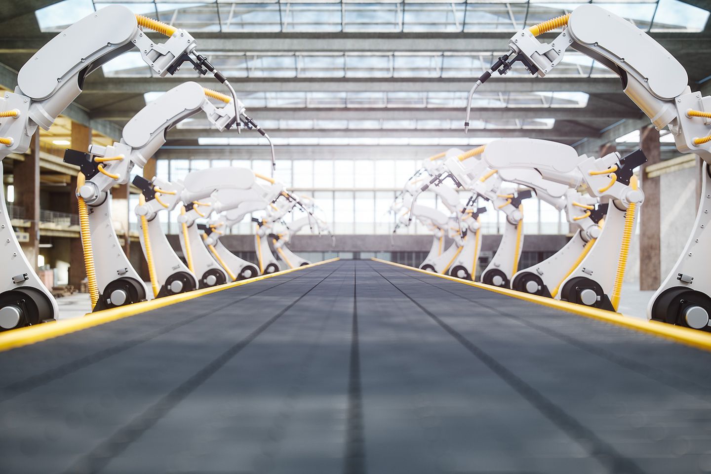 Several robot arms in an otherwise empty factory