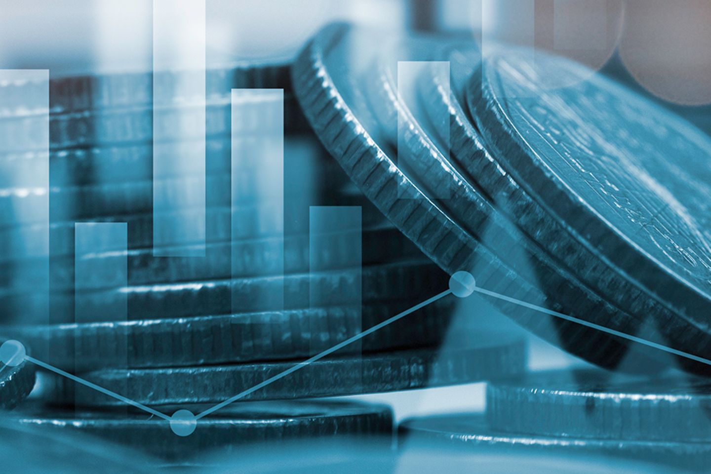 A stack of coins, in the foreground a bar chart.