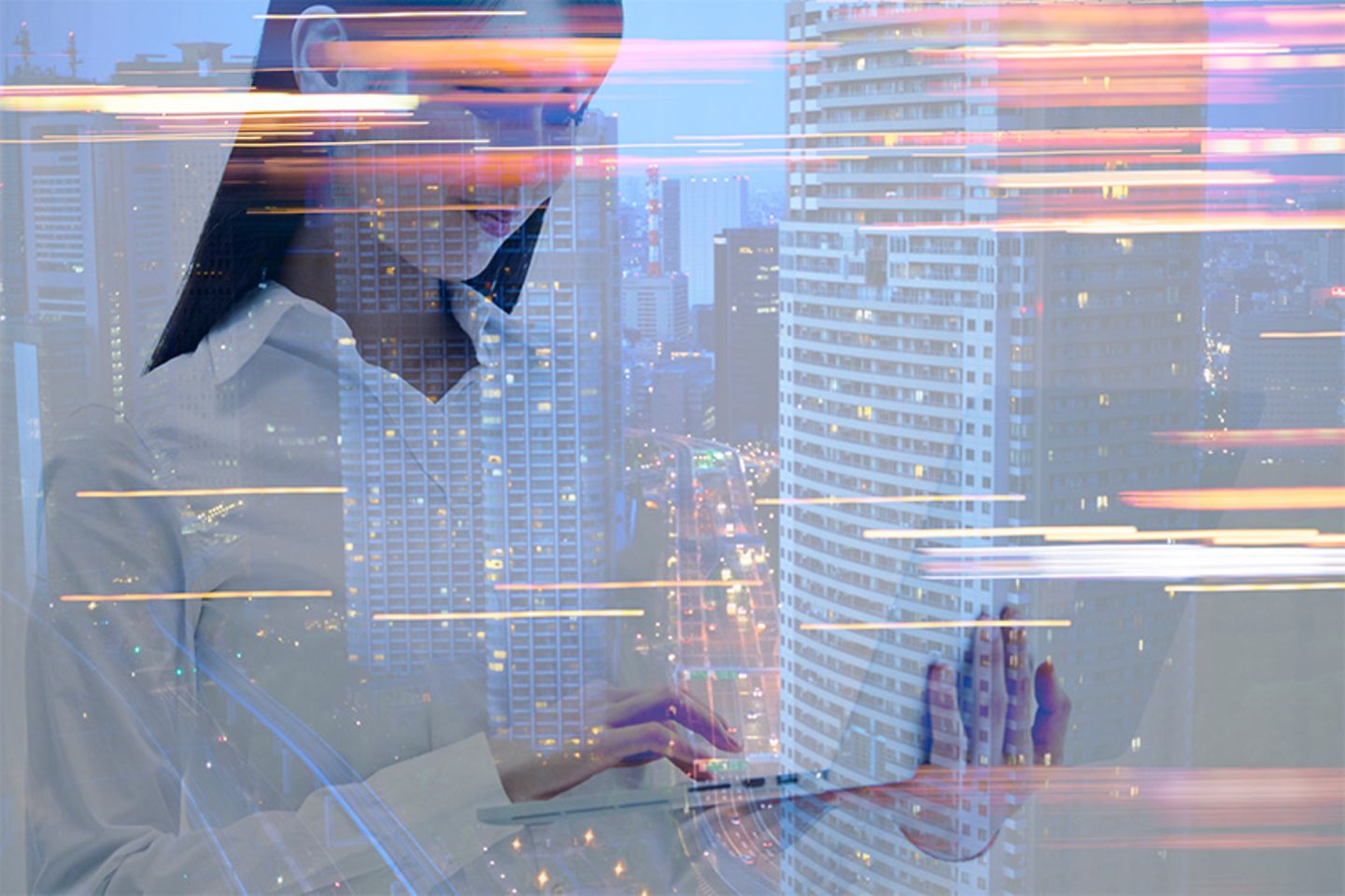 Woman with laptop and light effects in front of skyscrapers