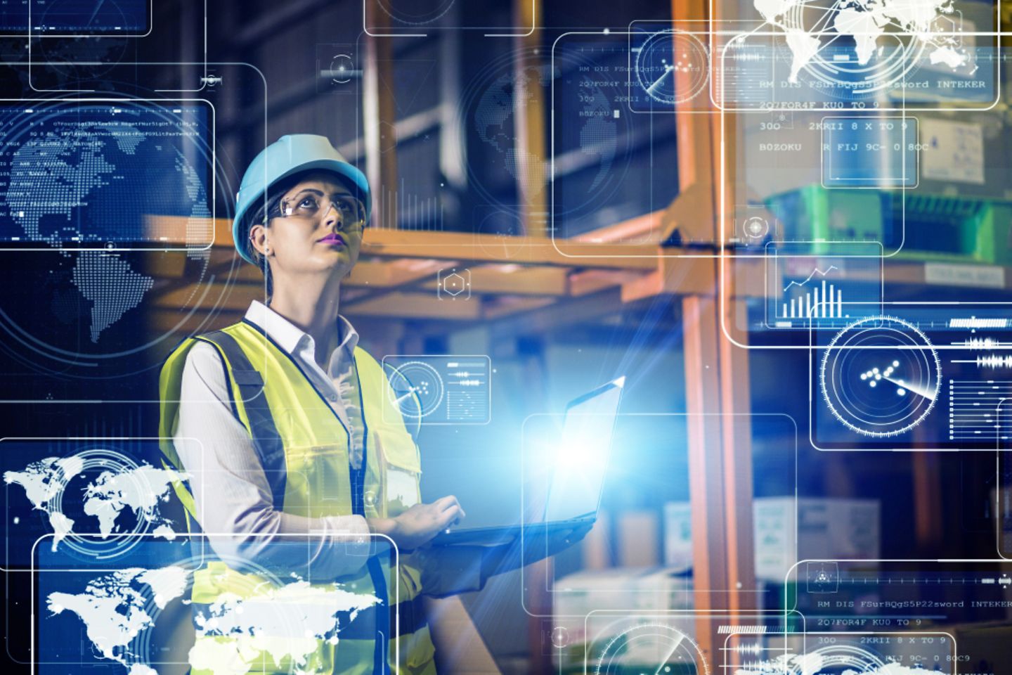 Woman in safety clothing with laptop in front of storage racks. Laptop projects virtual logistics icons into the foreground.