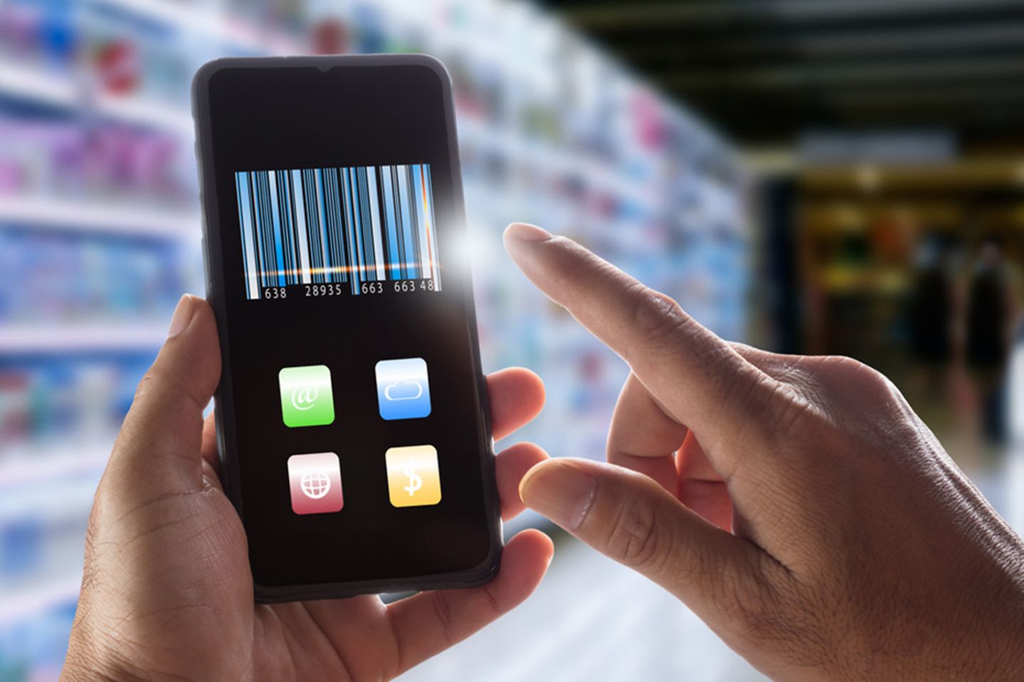 Hand holding smartphone with QR code on display in front of supermarket shelf