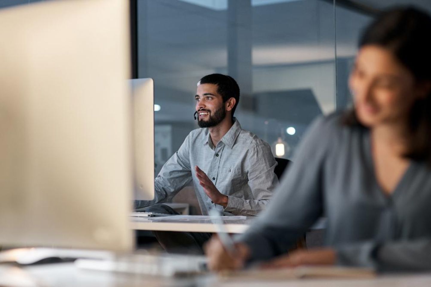 A man and a woman working on a computer